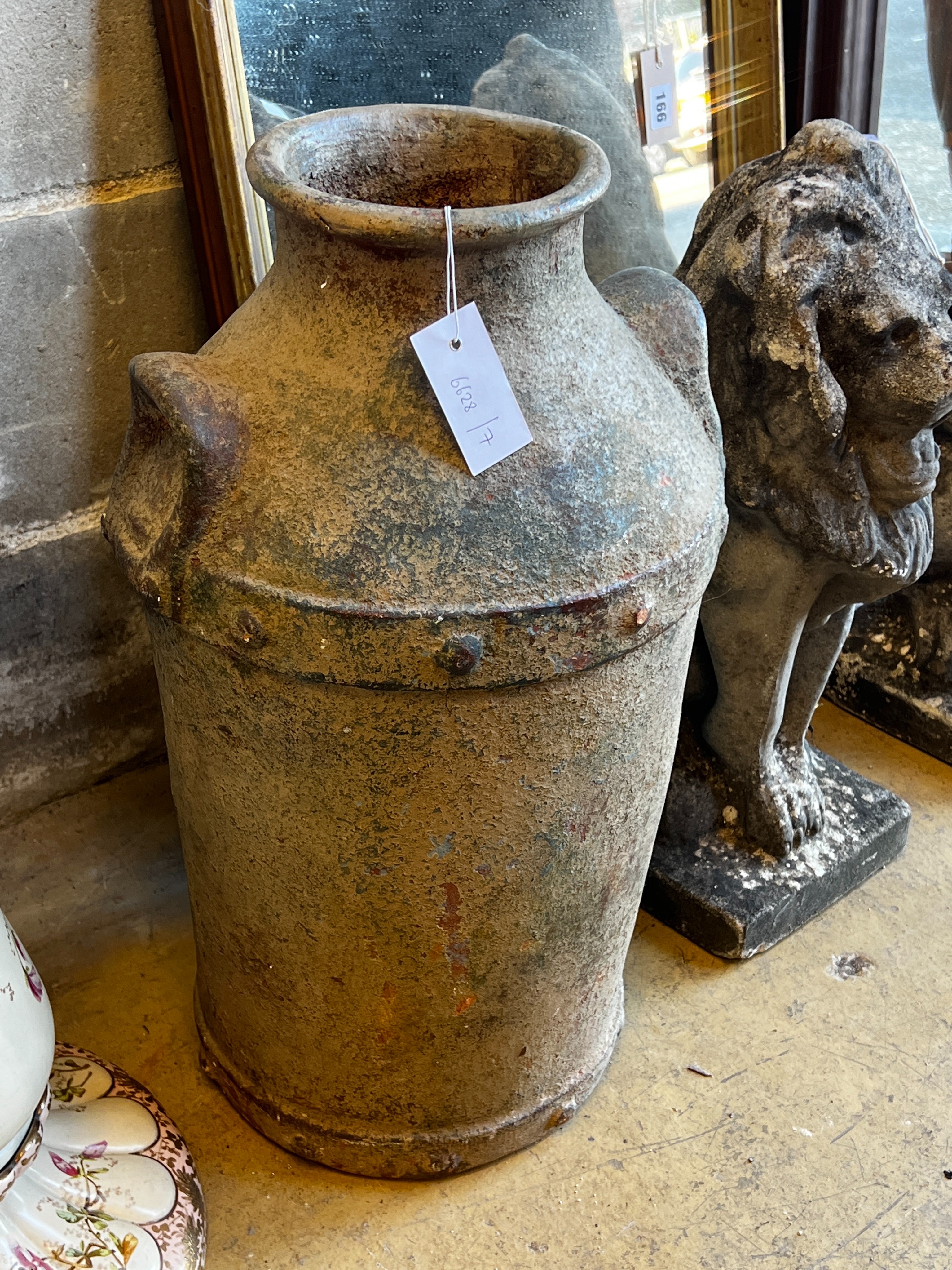 A glazed earthenware faux cast iron urn modelled as a milk churn, height 56cm